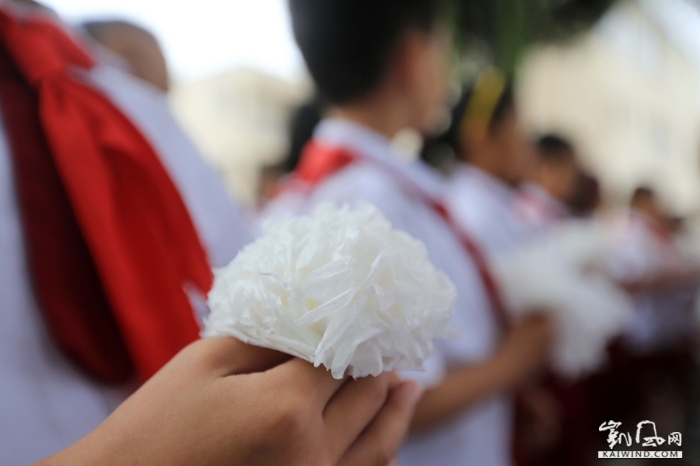 图2：9月30日，在广西柳州市融安县长安镇一处烈士纪念碑前，小学生在烈士纪念碑敬献手工制作的白花。（谭凯兴摄）副本