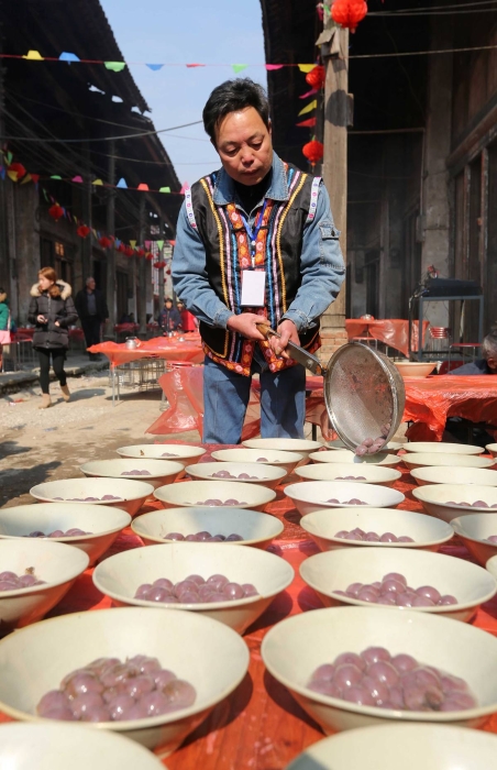 图9：2月11日，广西柳州市融安县板榄镇社区，一名社区居民在准备“长街宴”吃的汤圆。（谭凯兴 摄）