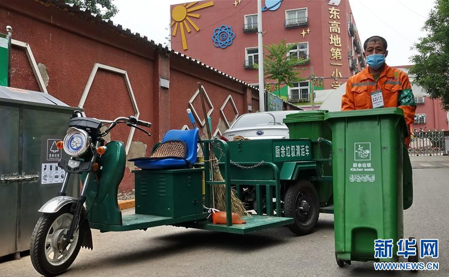 5月22日，丰台区东高地街道的社区工作人员在运送分类垃圾桶。 北京市实施垃圾分类以来，丰台区东高地街道在各个社区内全部安置了分类垃圾桶、分类指示牌，建立了分类垃圾运送、消毒防疫、居民分类投放等一系列制度，并为居民发放家用分类垃圾桶，促进和方便居民实施家庭垃圾分类。 新华社记者 李欣 摄