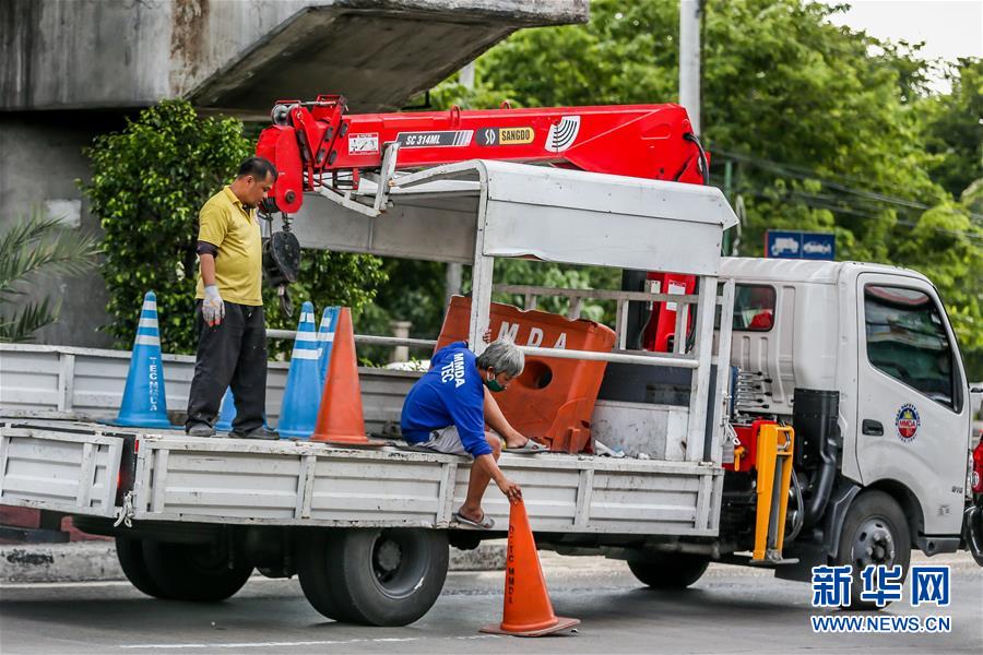 5月31日，在菲律宾首都马尼拉，工作人员用锥筒隔出公交车道，为放松隔离政策后的交通高峰做准备。菲律宾总统杜特尔特28日晚宣布，该国将从6月1日起放松首都马尼拉、第三大城市达沃等多地的严格社区隔离政策，实施一般性社区隔离政策。 新华社发（乌马利摄）