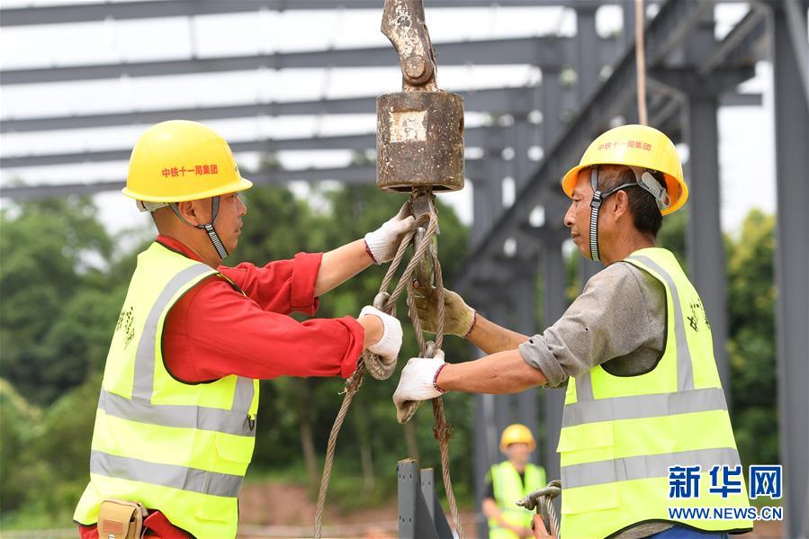 6月9日，工人在位于重庆市巴南区的渝湘高铁重庆段建设工地现场作业。新华社记者 唐奕 摄