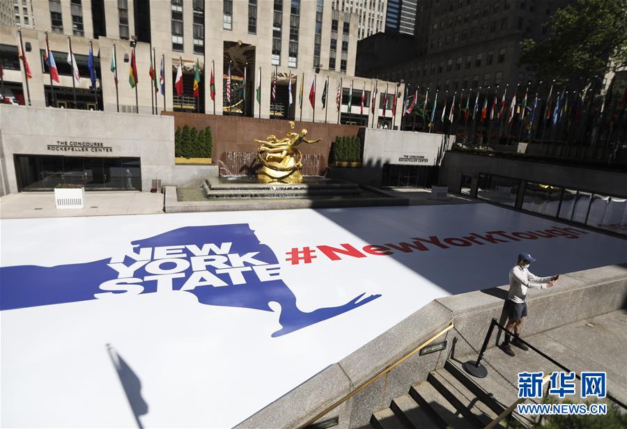 6月22日，在美国纽约洛克菲勒中心，一名男子在写有“纽约坚强”字样的广场自拍。 美国约翰斯·霍普金斯大学22日发布的新冠疫情最新统计数据显示，美国累计死亡病例超过12万例。 新华社记者王迎摄