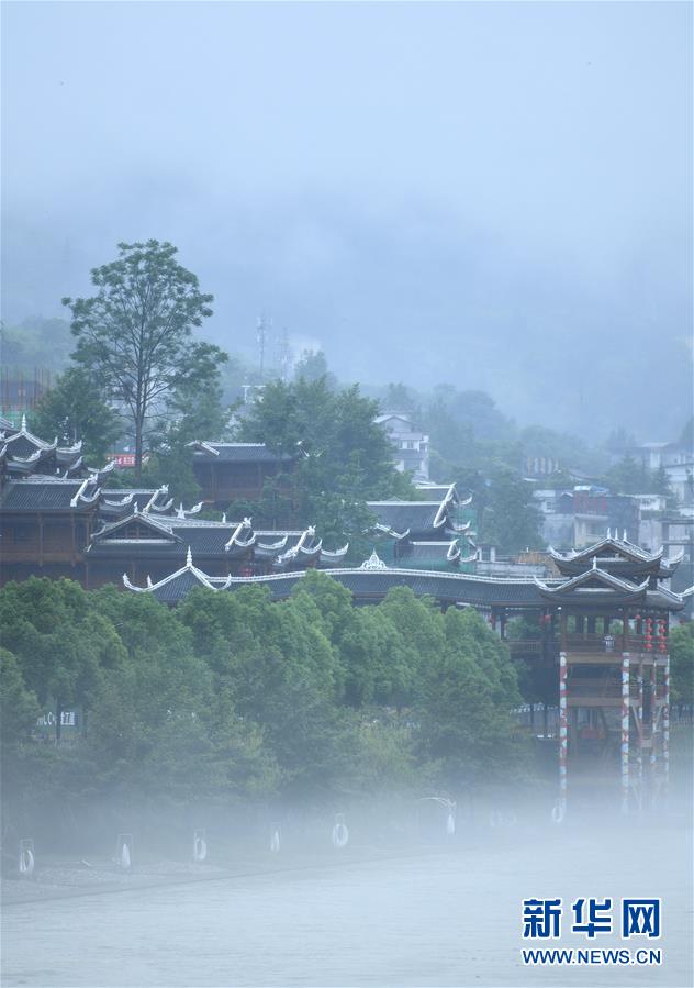 6月23日，一场雨后，湖北省恩施土家族苗族自治州宣恩县贡水河雾气升腾，河畔亭台楼阁若隐若现，宛若仙境。 新华社发（宋文 摄）