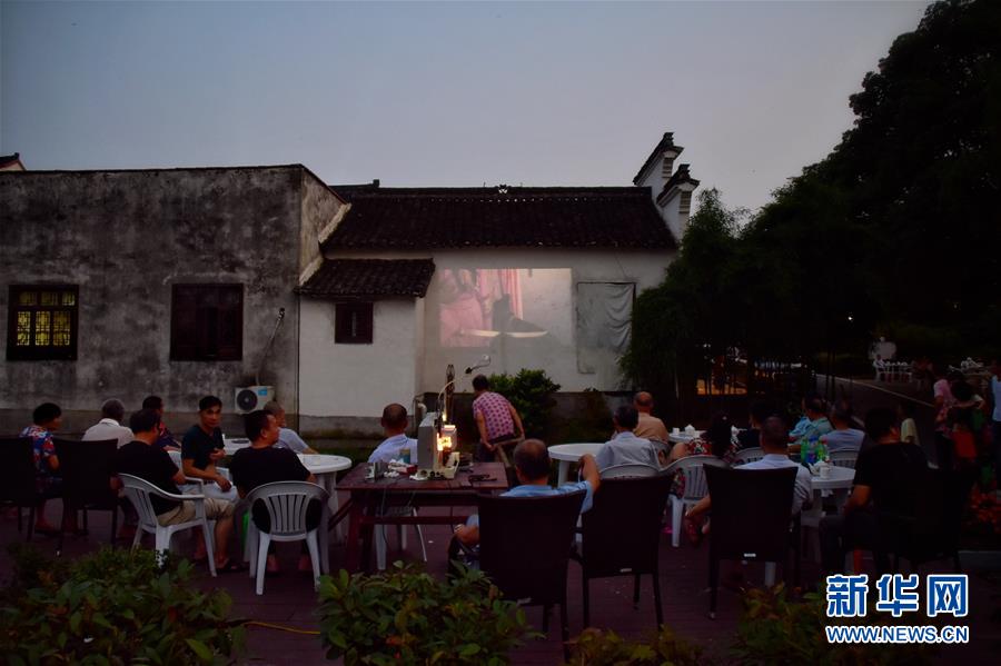 6月30日，天色渐暗，村民自发围坐在广场观看电影。新华社记者 郑梦雨 摄