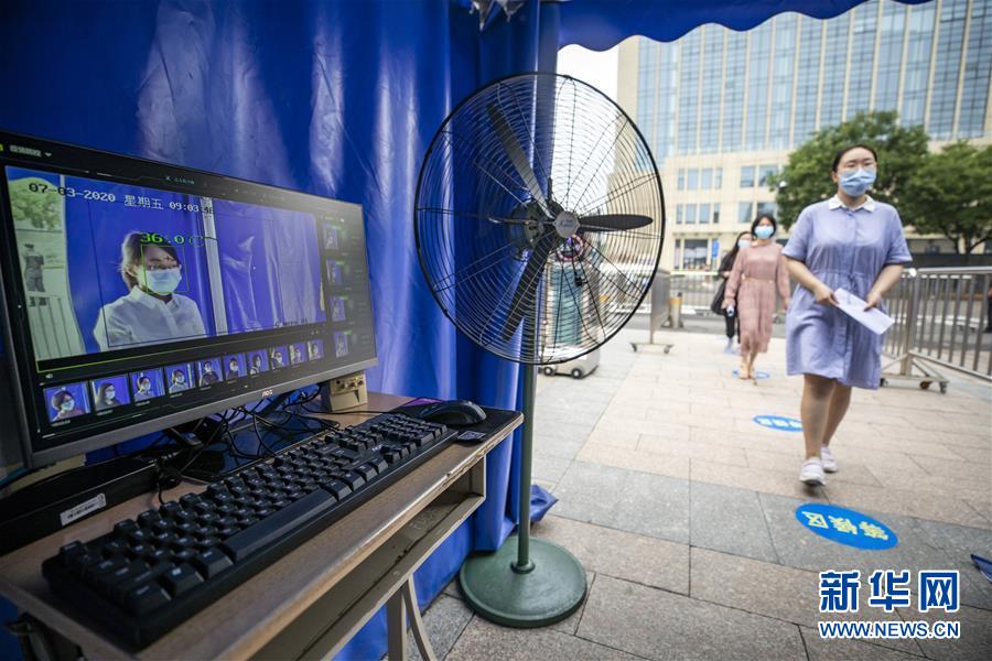 7月3日，北京市第十二中学考点老师在模拟演练考生经过测温设备后进入考点。　2020年全国高考即将拉开帷幕，各地精心做好各项准备工作。 新华社记者 沈伯韩 摄