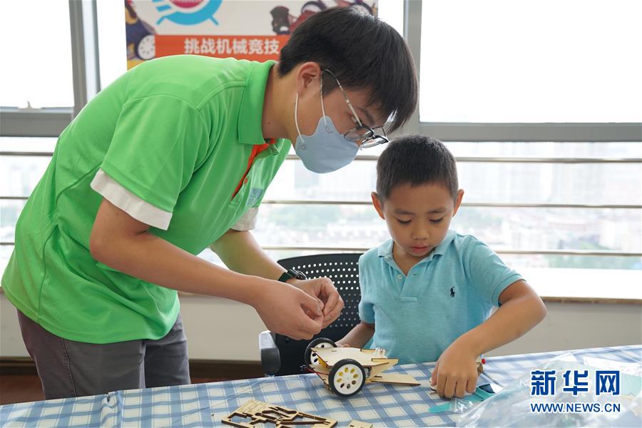 7月15日，在“大国小工匠”技能体验活动上，老师指导孩子设计车辆结构模型。 当日，“大国小工匠”技能体验活动在中国（上海）创业者公共实训基地举行。该活动是7·15世界青年技能日主题系列活动之一。 新华社记者 滕佳妮 摄