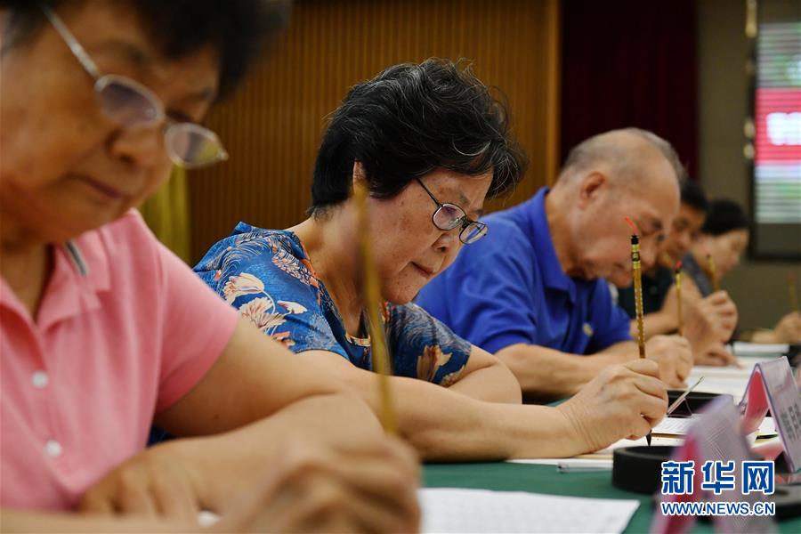 8月13日，陕西师范大学退休教师韩月娥（左二）等书写录取通知书。 当日，陕西师范大学2020年手写录取通知书正式开笔。该校自2007年起采用毛笔书写录取通知书的方式，为新生传递佳音。今年，学校十余位退休教师、在职教师、校友代表等书法爱好者将为约4500名新录取的本科生送上带着墨香的大学录取通知书。 新华社记者 张博文 摄