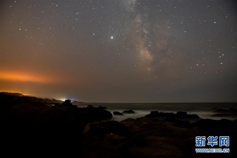 这是8月17日晚在美国加利福尼亚州的半月湾附近拍摄的夜空。 美国加利福尼亚州近日炎热干燥，野火肆虐，入夜后火光映红天空。 新华社发（董旭东摄）