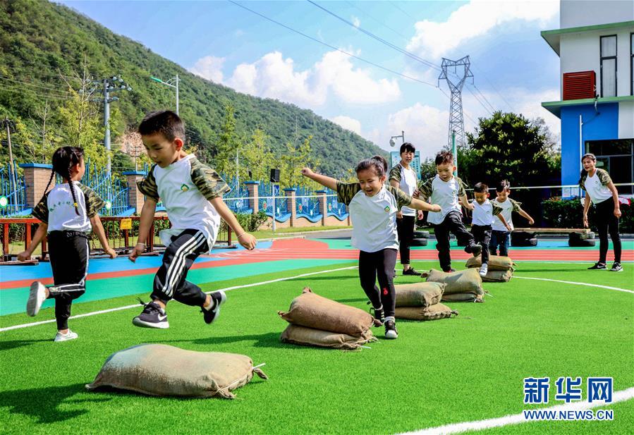 9月24日，孩子们在老师的带领下进行跨越障碍物运动。 当日，浙江省湖州市长兴县煤山镇槐坎中心幼儿园开展校园金秋运动日活动。孩子们在老师和家长志愿者的带领下，进行走、跑、跳、平衡等户外拓展运动技能的练习，让孩子们在快乐中锻炼身体。 新华社记者 徐昱 摄