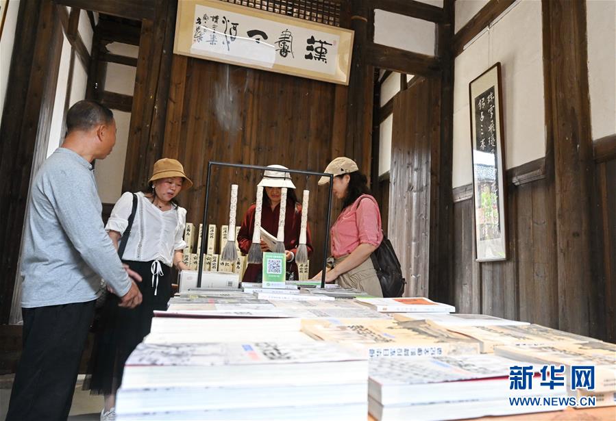 10月21日，游客在福州梁厝特色历史文化街区的一处古厝书屋里翻阅书籍。 梁厝特色历史文化街区位于福州仓山区城门镇梁厝村，近年来，当地依托梁厝村的历史文化底蕴，对村内古厝进行修缮保护，对村庄环境美化改造提升，打造成特色历史文化街区，带动乡村旅游产业发展。 新华社记者 林善传 摄