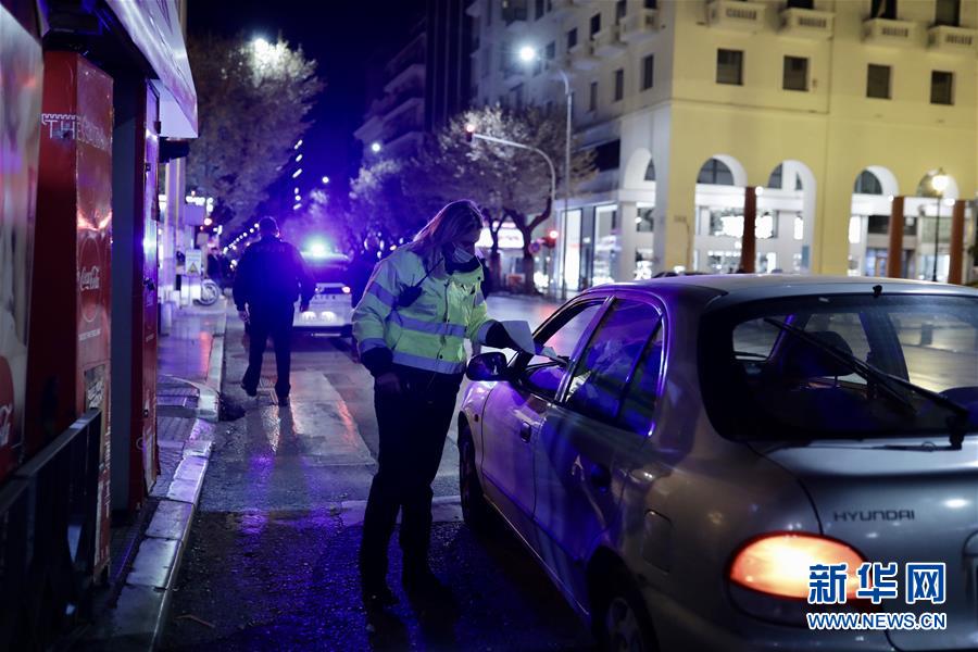10月25日凌晨，警察在希腊塞萨洛尼基对过往车辆进行检查。 为防控疫情，希腊对多个地区实施宵禁等管控措施。 新华社发（莱夫泰里斯·帕特萨利斯摄）