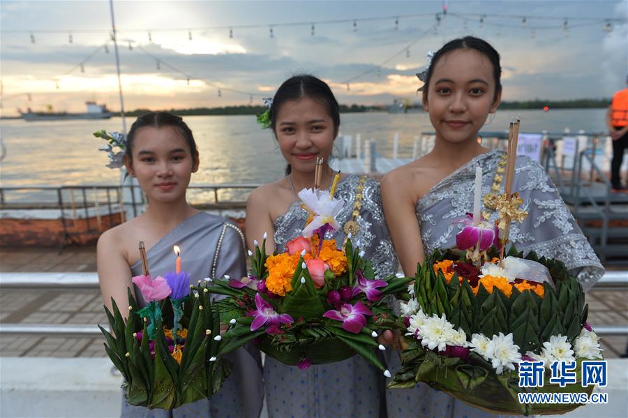10月31日，身穿泰国传统服饰的女孩在曼谷湄南河边展示她们的水灯。当日是泰国传统节日水灯节，泰国各地民众前往河流或湖泊沿岸施放水灯，祈求流水带走厄运，未来幸福如意。新华社发（拉亨摄）