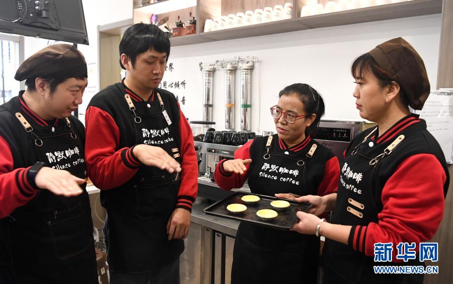 西安“静默咖啡”的店长王丽超（右二）指导三名店员制作蛋挞（12月1日摄）。新华社记者 刘潇摄