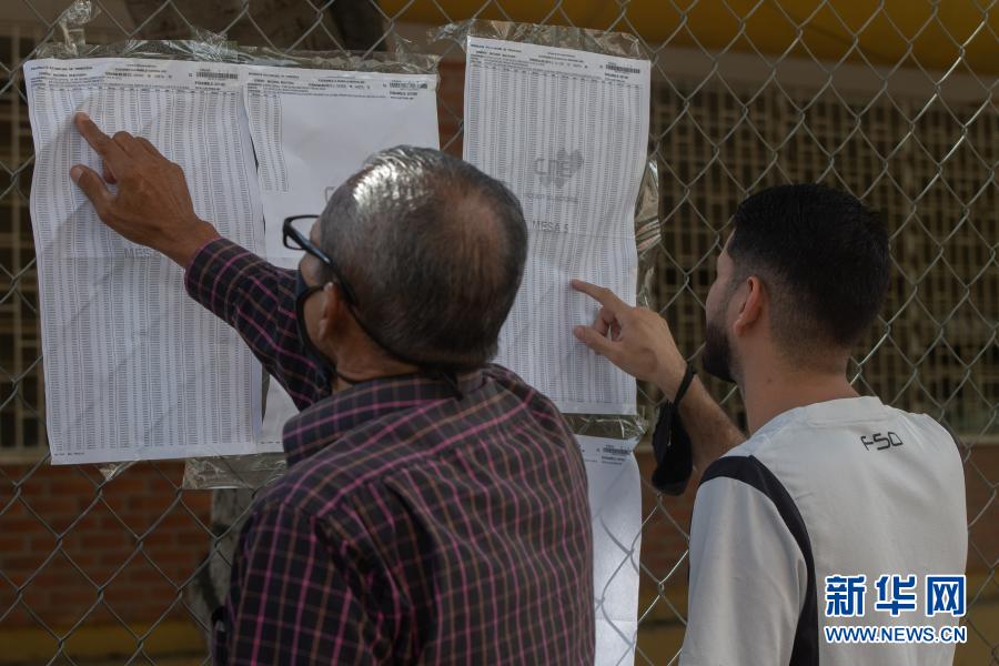 12月6日，市民在委内瑞拉加拉加斯一个投票站外核对选民名单上的信息。12月6日，委内瑞拉举行议会选举。新华社发（萨尔戈多摄）