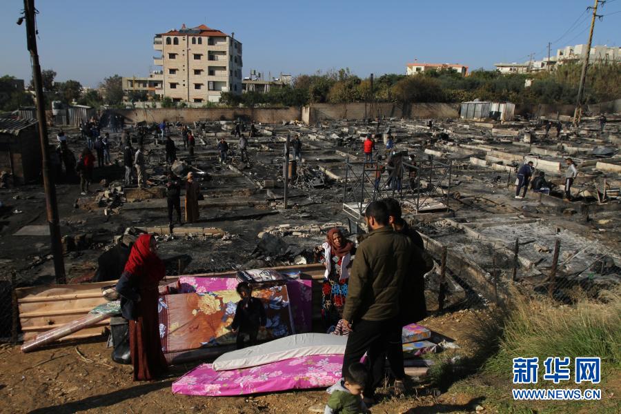 12月27日，在黎巴嫩北部明耶地区，人们回到被烧的难民营寻找可用物品。黎巴嫩北部明耶地区26日发生当地民众与叙利亚难民之间的冲突，造成至少5人受伤、约100个帐篷被烧。新华社发（哈利德摄）