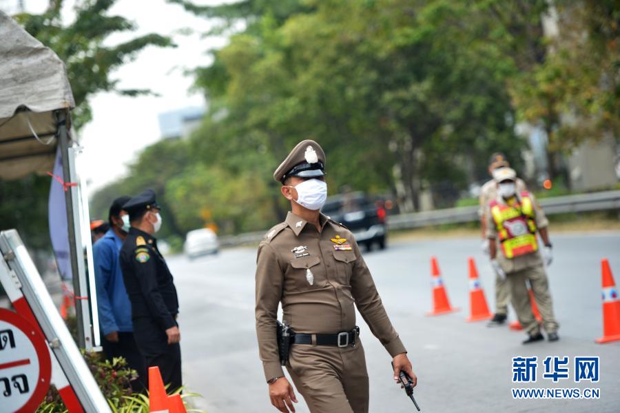 1月5日，警察在泰国曼谷的一处防疫检查站工作。泰国自1月4日起开始对包括曼谷在内的全国28个府级行政区实施为期1个月的严格管制措施，以控制疫情快速蔓延趋势。新华社发（拉亨 摄）
