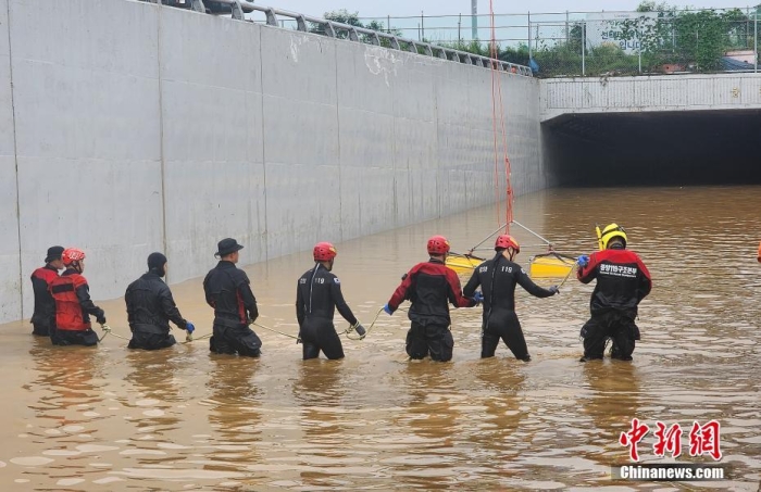 韩国救援人员沿着一条被洪水淹没的道路搜寻失踪人员,这条道路通往被洪水淹没的地下隧道。视觉中国 韩国救援人员沿着一条被洪水淹没的道路搜寻失踪人员,这条道路通往被洪水淹没的地下隧道。视觉中国